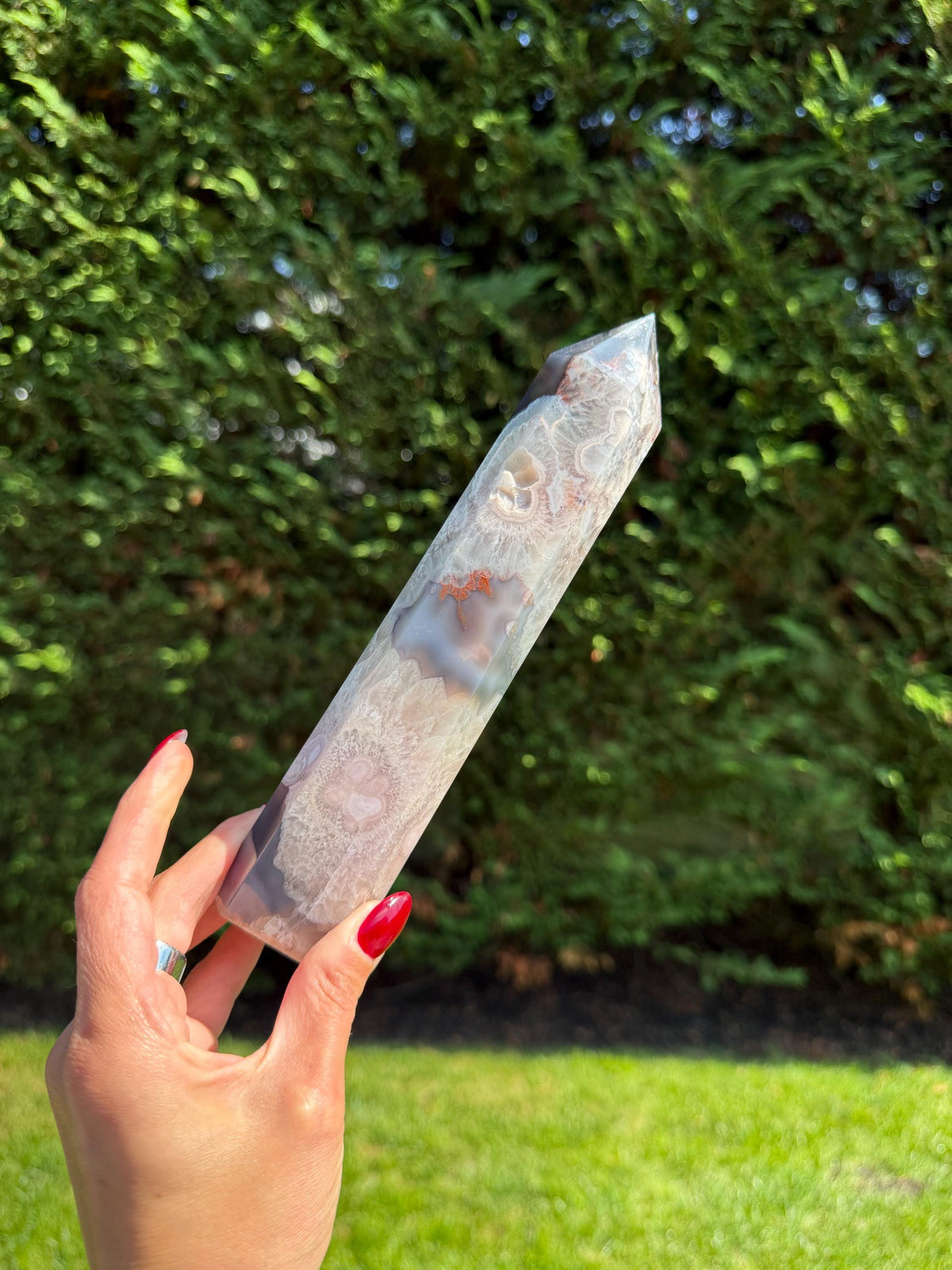 Close-up of Black Flower Agate Druzy Tower highlighting intricate flower patterns and sparkling druzy.