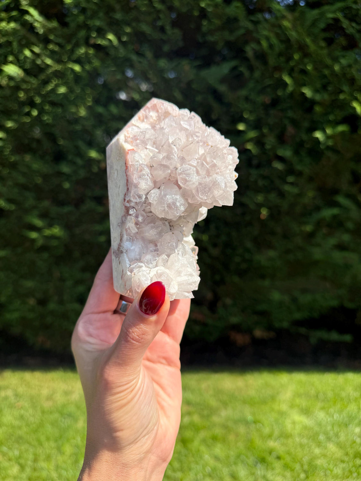 Brazilian pink amethyst freeform with shimmering druzy cavities and soft pink crystal texture.