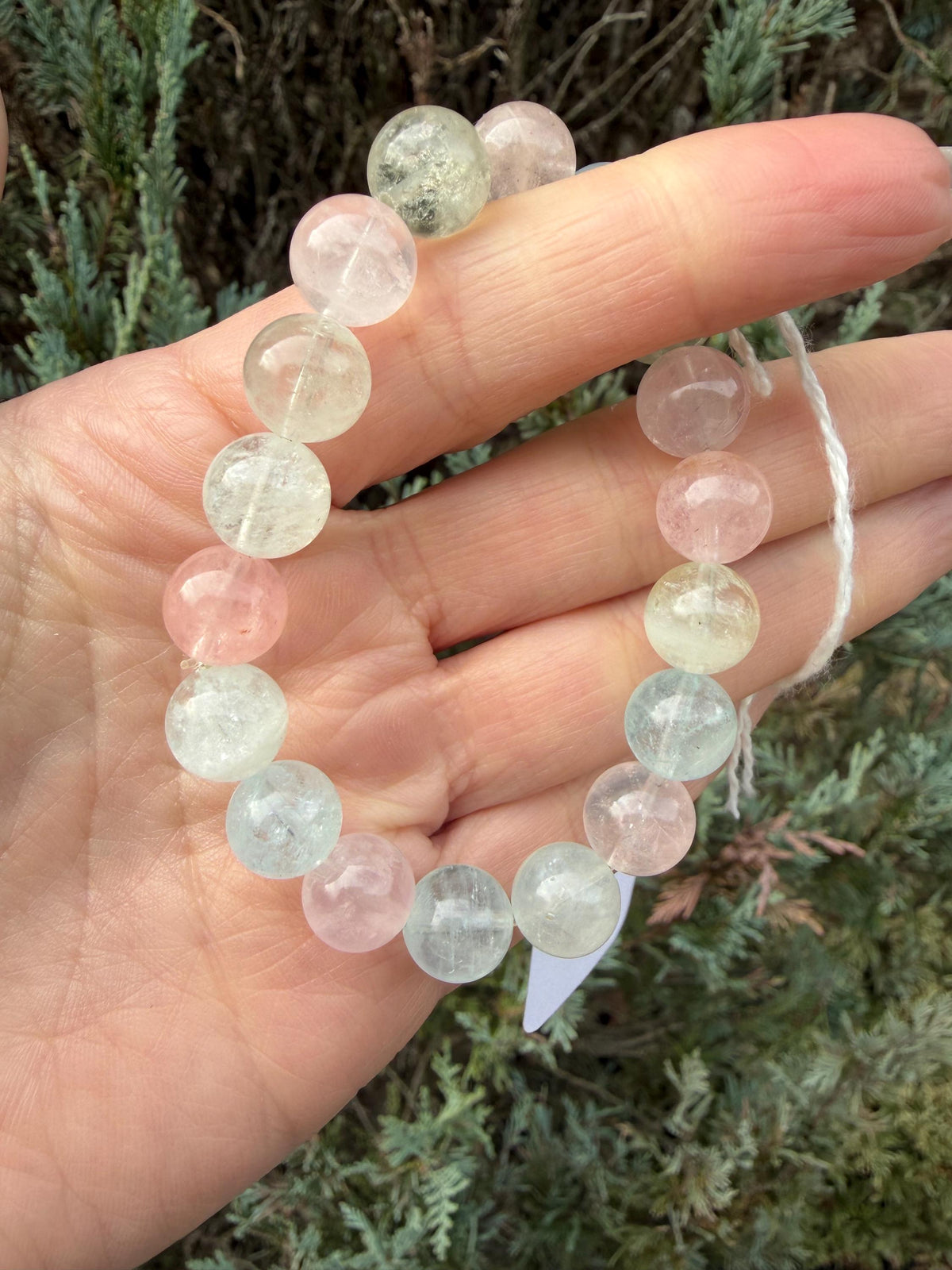 Polished 10mm Mixed Beryl beads showing bright pastel blue, pink, yellow, and clear tones.