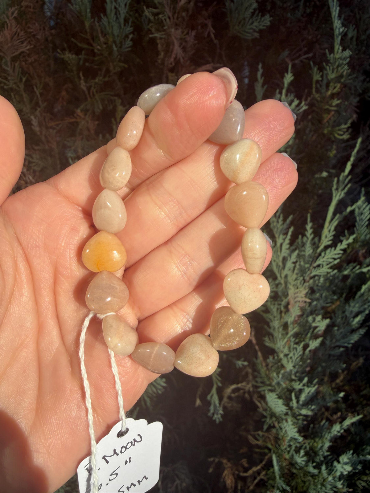Close-up of Peach Moonstone heart bead showing soft peach tones and natural shimmer.