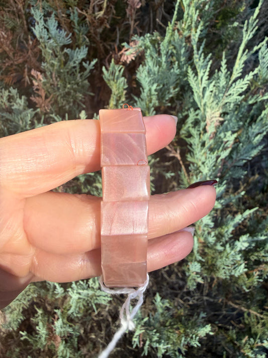 Close-up of Peach Moonstone soft bangle showing natural shimmer and soft peach tones.