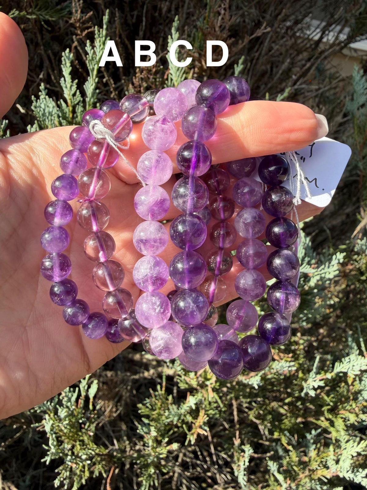 Assorted amethyst beaded bracelets in multiple bead sizes with natural purple gemstone beads.