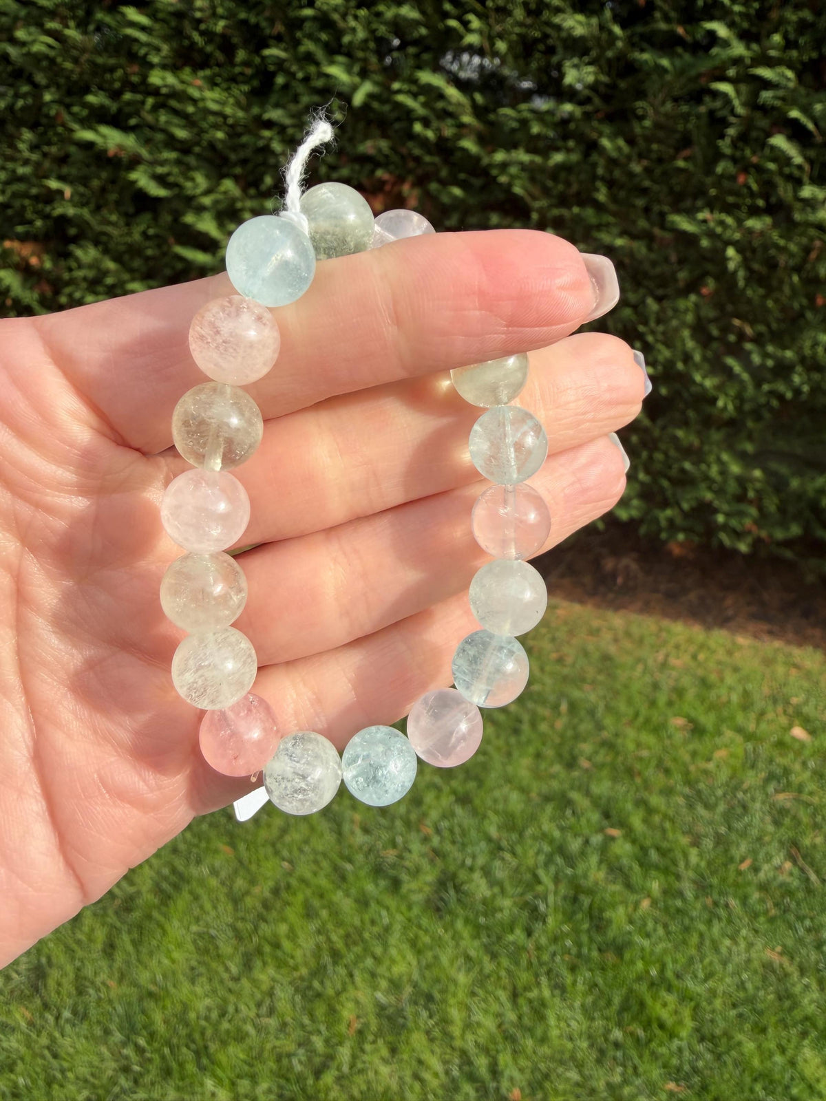High quality 10mm Mixed Beryl beaded bracelet with aquamarine, morganite, heliodor, and goshenite pastel gemstones.