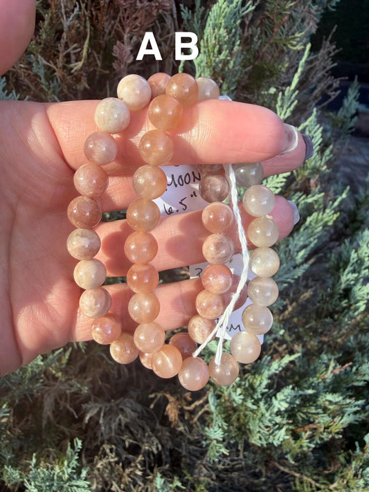 Mixed Peach Moonstone and Sunstone beaded bracelet highlighting pastel peach and golden-orange gemstone beads.