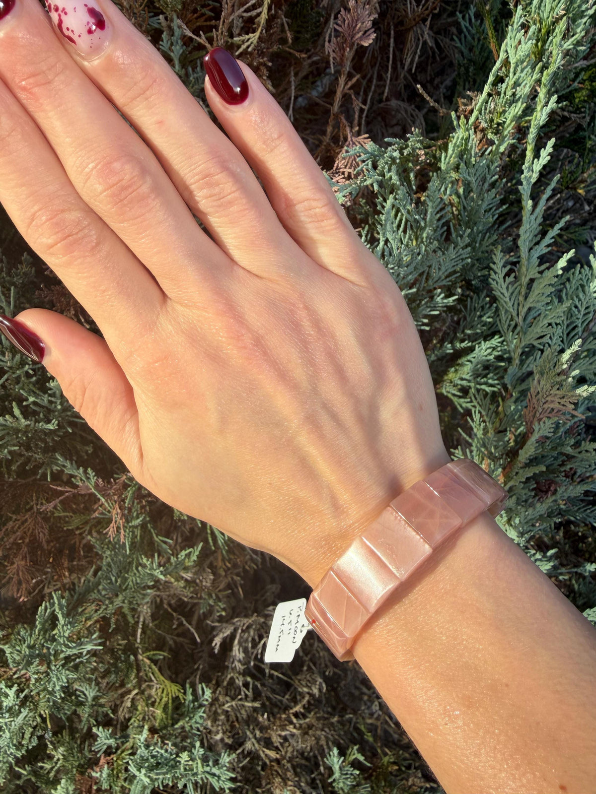 Peach Moonstone soft bangle bracelet worn on wrist with flexible fit and polished beads.