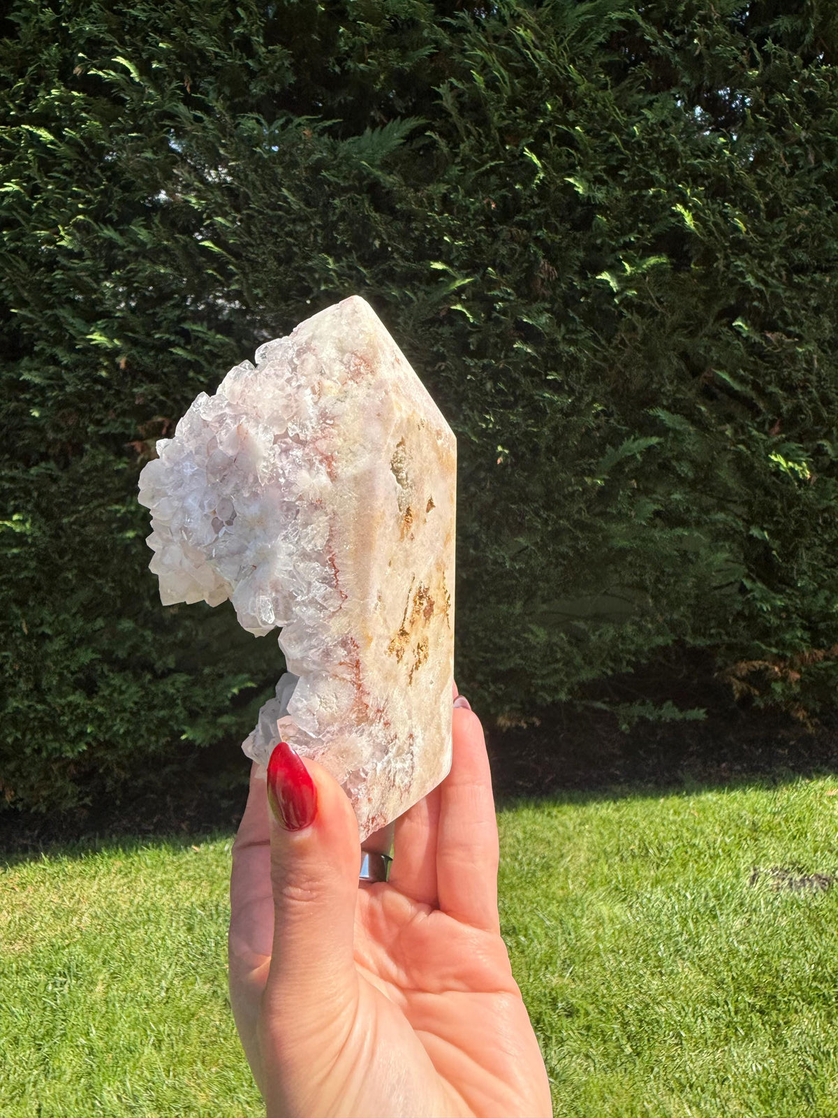 Polished pink amethyst freeform from Brazil showing glittery druzy clusters and flowing banding.
